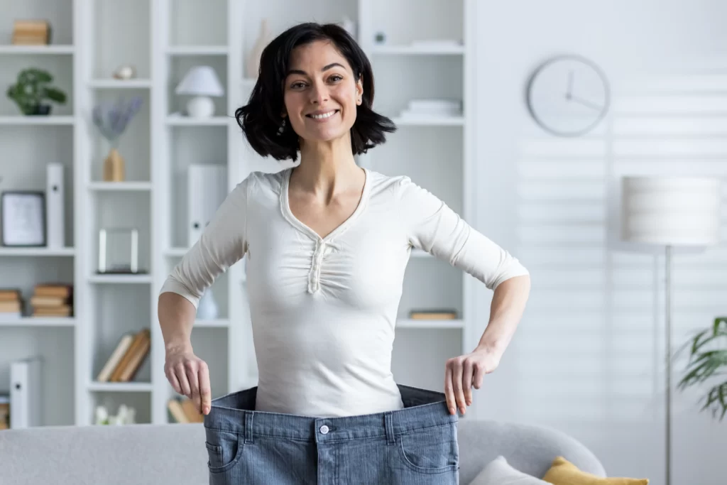 portrait of a young smiling woman standing at home utc